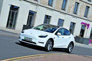 tesla model y cornering through town